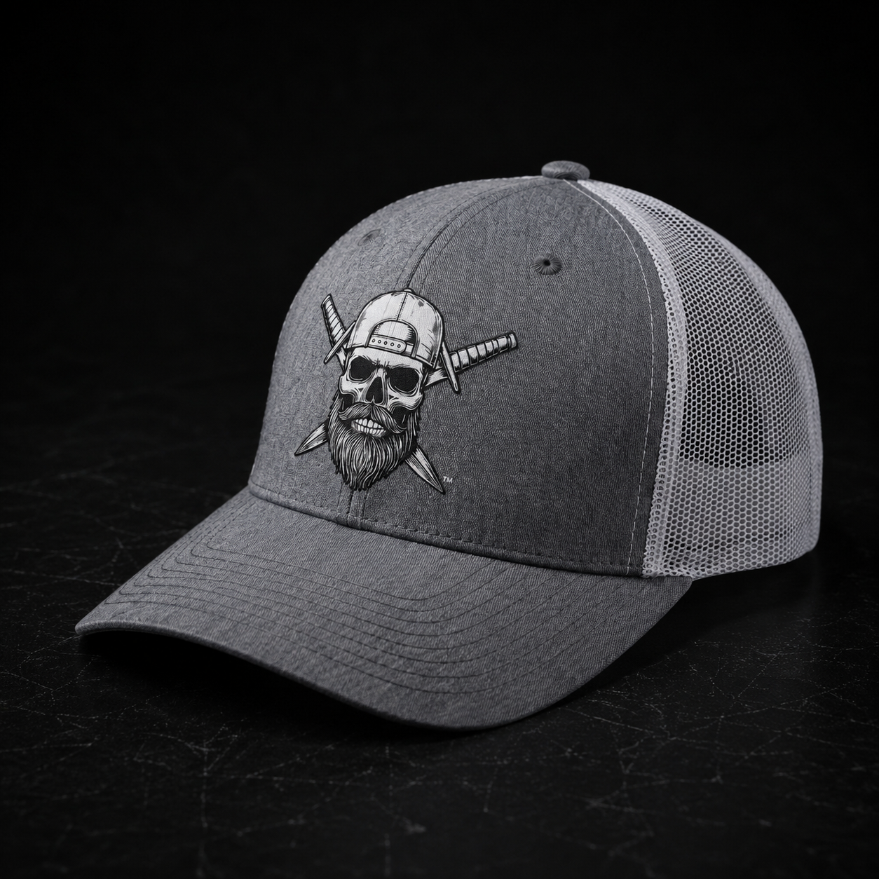 Front view of the Spec Ops Water FORGED heather gray and white trucker hat featuring the Skull & Swords logo.
