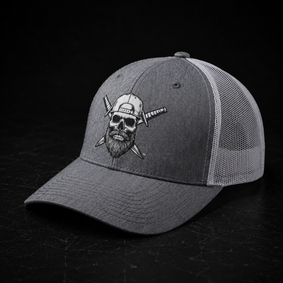 Front view of the Spec Ops Water FORGED heather gray and white trucker hat featuring the Skull & Swords logo.